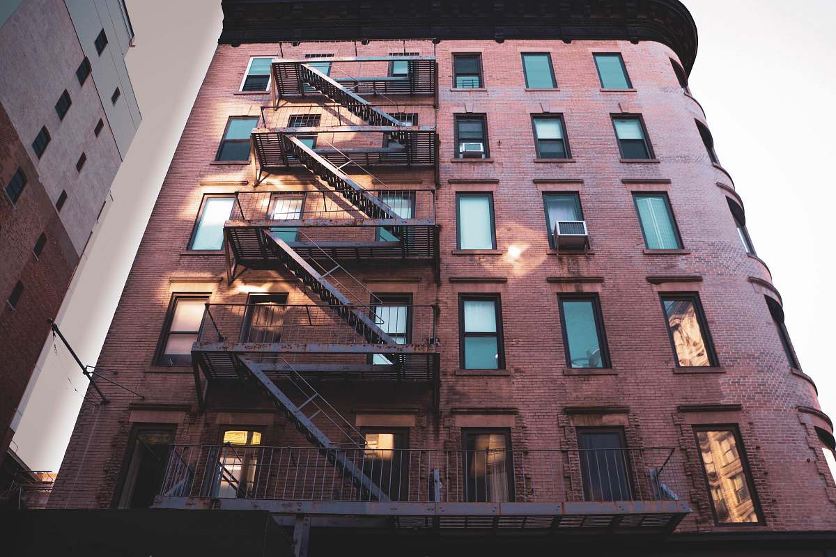 high rise brown mid rise building with fire exit stairs town